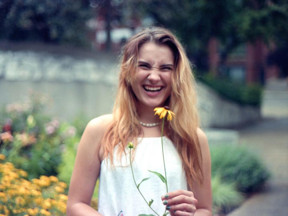 Woman smiling with flower