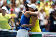 Australia's Ashleigh Barty hugs France's Caroline Garcia at the net after their Fed Cup tennis final in Perth, Australia, Saturday, Nov. 9, 2019. (AP Photo/Trevor Collens)