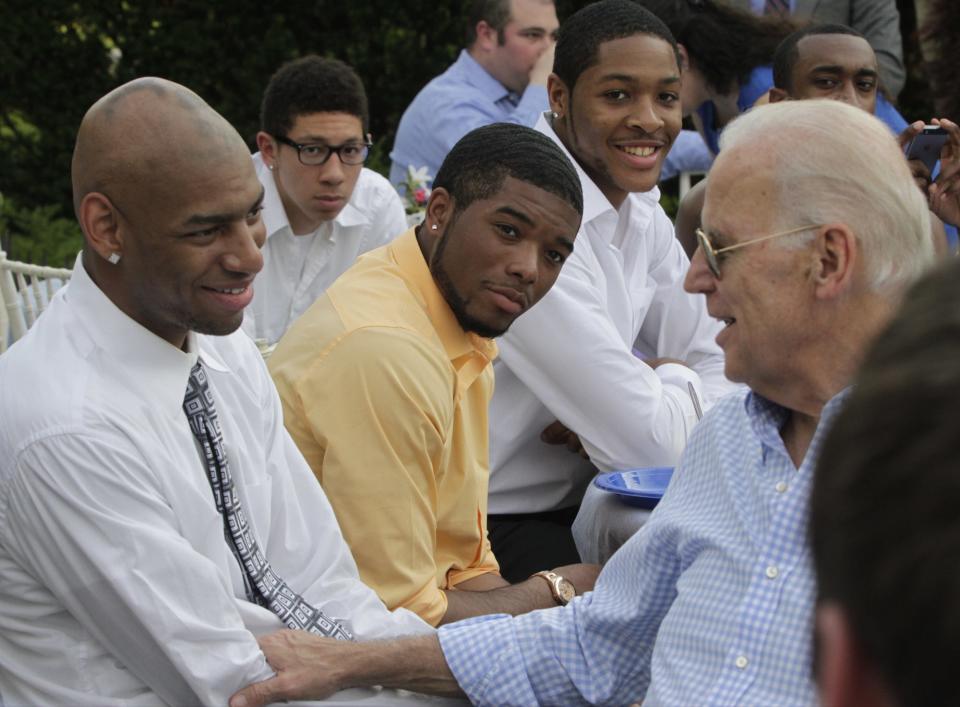 Vice President Joe Biden chats with University of Delaware basketball player Barnett Harris (left) and teammates at his Naval Observatory residence in Washington, D.C., May 8, 2014.