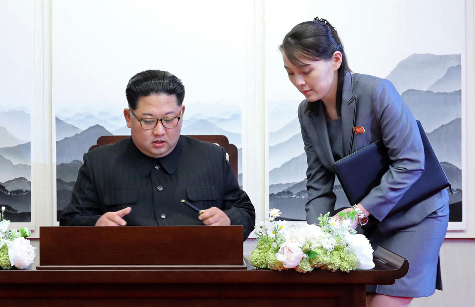 FILE - In this April 27, 2018, file photo, North Korean leader Kim Jong Un signs a guestbook next to his sister Kim Yo Jong, right, inside the Peace House at the border village of Panmunjom in Demilitarized Zone. With North Korea saying nothing so far about outside media reports that leader Kim Jong Un may be unwell, there’s renewed worry about who’s next in line to run a nuclear-armed country that’s been ruled by the same family for seven decades. (Korea Summit Press Pool via AP, File)