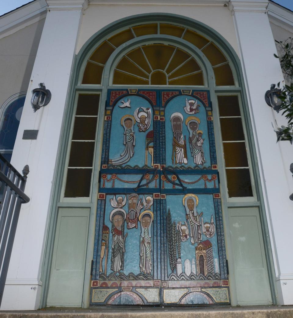 The carved wooden doors by artists Jonathan Kendall and Charles McLeod at the Wellfleet Preservation Hall which was originally the Our Lady of Lourdes Catholic Church along Main Street.