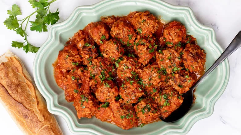 Meatballs in serving dish with French bread