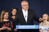 Australian Prime Minister Scott Morrison, second right, speaks to party supporters flanked by his wife, Jenny, second left, and daughters Lily, right, and Abbey, after his opponent concedes in the federal election in Sydney, Australia, Sunday, May 19, 2019. Australia's ruling conservative coalition, lead by Morrison, won a surprise victory in the country's general election, defying opinion polls that had tipped the center-left opposition party to oust it from power and promising an end to the revolving door of national leaders. (AP Photo/Rick Rycroft)