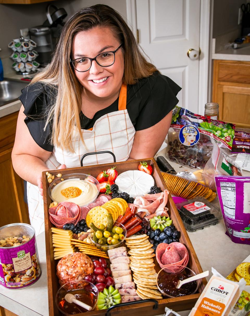 Serena Shumate, a mother of four, shows a charcuterie board made for a customer at her home in Ocala Thursday afternoon. She started making charcuterie boards for family and friends and now has made it into a business called The Charcuterie Mama. She creates other boards like breakfast and candy trays for holidays, events and special occasions.