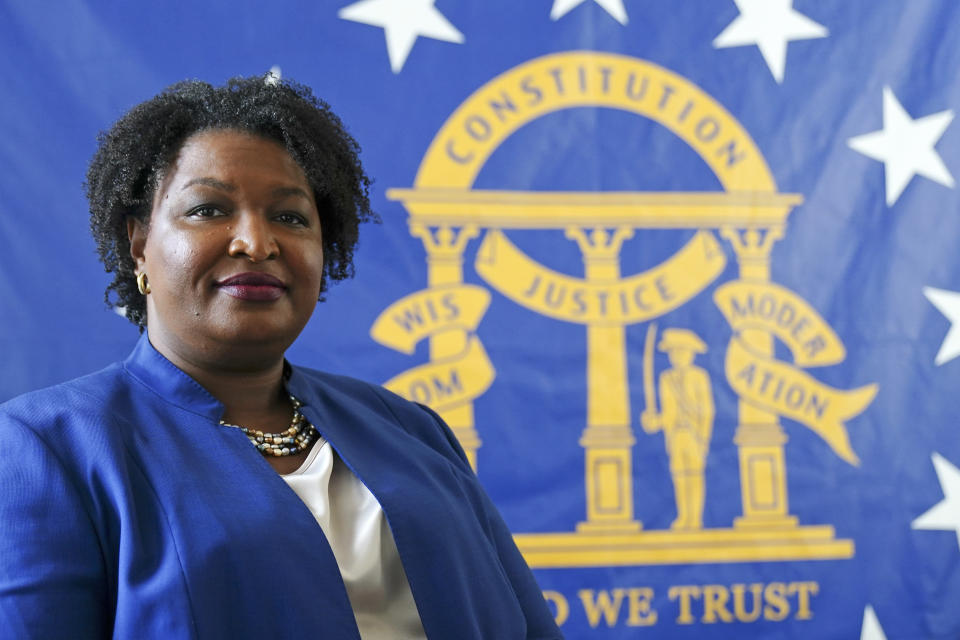 FILE - Democratic candidate for Georgia governor Stacey Abrams poses for a portrait in front of the State Seal of Georgia on Aug. 8, 2022, in Decatur, Ga. On Friday, Oct. 14, The Associated Press reported on stories circulating online incorrectly claiming Abrams lobbied for moving Major League Baseball’s 2021 All-Star Game and Atlanta’s 2022 Music Midtown festival out of Georgia. (AP Photo/John Bazemore, File)