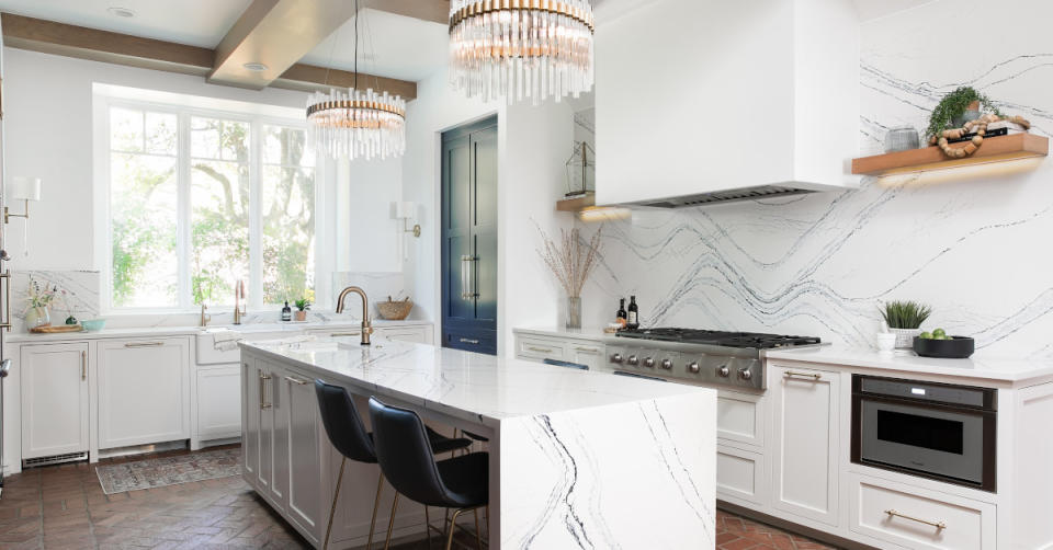 a white kitchen with white stone countertop