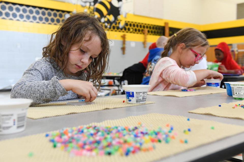 Bryleigh Mclain, 6, and Samara Smook, 6, use plastic beads to make designs on Friday, September 24, 2021, at the Kid Inc. after school program at Laura B. Anderson Elementary School in Sioux Falls.