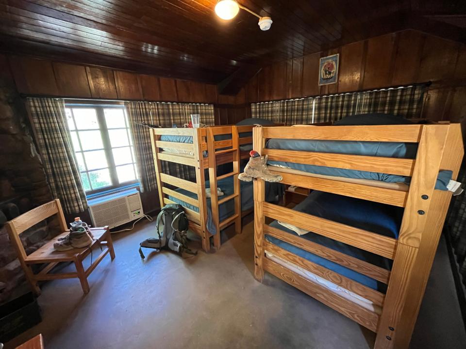 Bunk beds in a room with a chair.