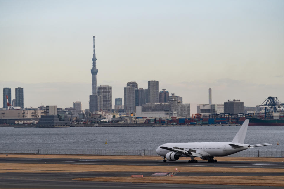 The back tower (left) is Tokyo Sky Tree. The airplane just landed at 