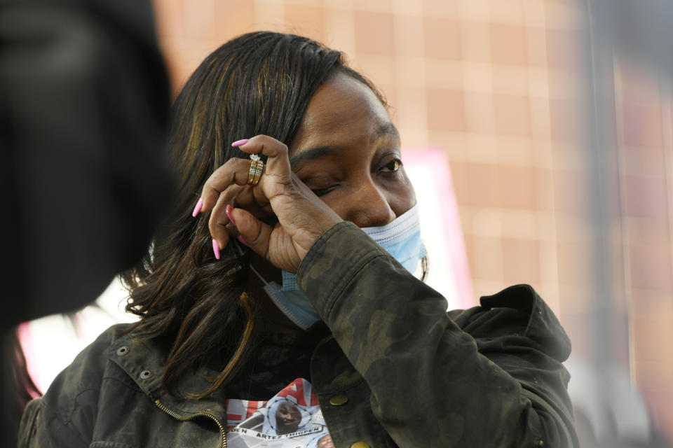 Cassandra Greer-Lee wipes a tear during a rally to protest former Chicago Mayor Rahm Emanuel's appointment as ambassador to Japan outside the Chicago Police Headquarters Tuesday, Oct. 19, 2021, in Chicago. Greer-Lee's husband Nickolas Lee died of COVID-19 in Cook County Jail in 2020. (AP Photo/Paul Beaty)