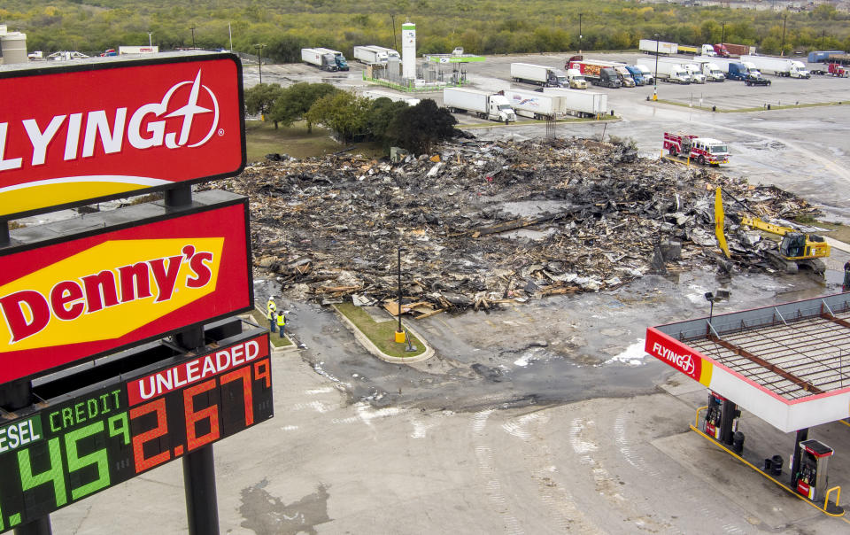 The remains of a combined Denny's restaurant and Pilot Flying J Travel Center near Interstate 10 are seen on Thursday, Dec. 1, 2022, after a morning fire destroyed the building in San Antonio. (William Luther/The San Antonio Express-News via AP)