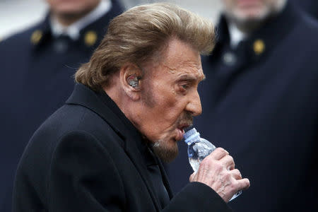 FILE PHOTO: French singer Johnny Hallyday prepares to perform during a ceremony at Place de la Republique square to pay tribute to the victims of last year's shooting at the French satirical newspaper Charlie Hebdo, in Paris, France, January 10, 2016. REUTERS/Charles Platiau/File Photo