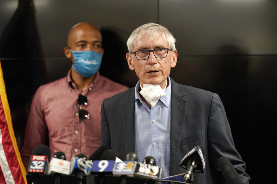 FILE - In this Aug. 27, 2020, file photo, Wisconsin Gov. Tony Evers speaks during a news conference in Kenosha, Wis., as Lt. Gov. Mandela Barnes, left, accompanies him. Gov. Evers made it official Saturday, June 5, 2021, announcing his bid for a second term in the battleground state where he stands as a Democratic block to the Republican-controlled state Legislature. (AP Photo/Morry Gash, File)