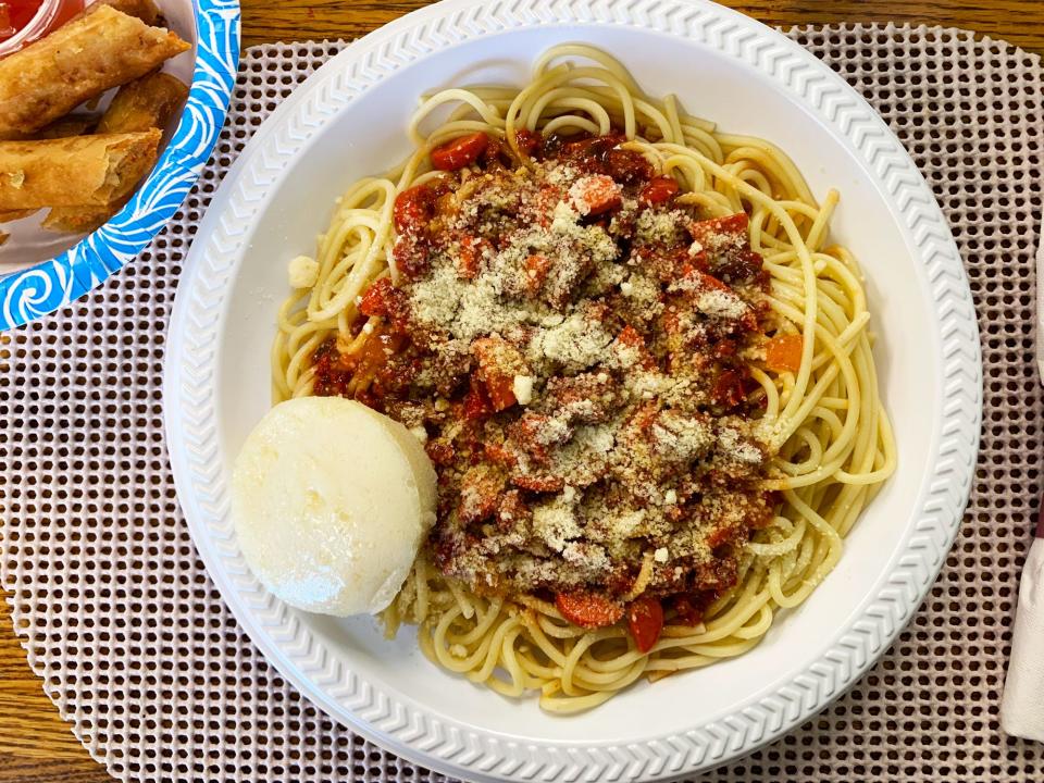 Filipino spaghetti is sweet with banana ketchup, and topped with hot dogs.