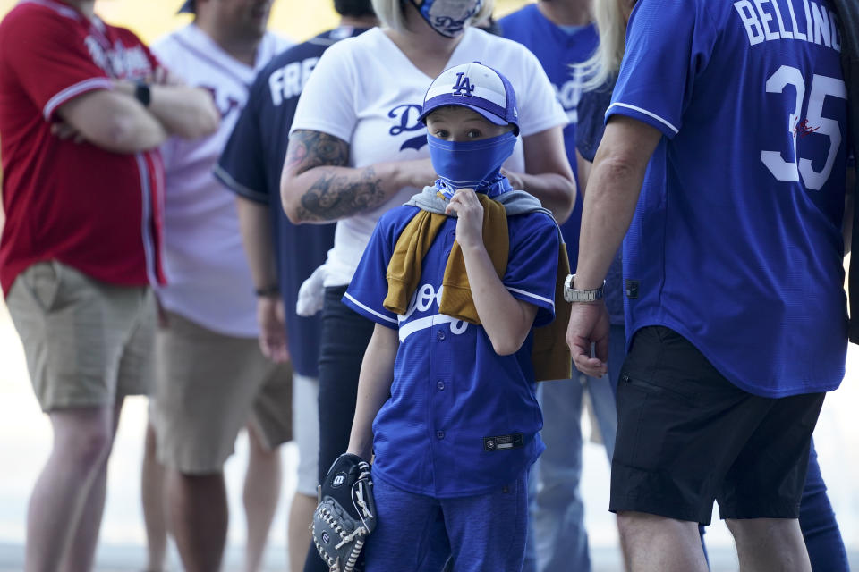 Fans arrive before Game 1 of a baseball National League Championship Series between the Los Angeles Dodgers and the Atlanta Braves Monday, Oct. 12, 2020, in Arlington, Texas. (AP Photo/Eric Gay)