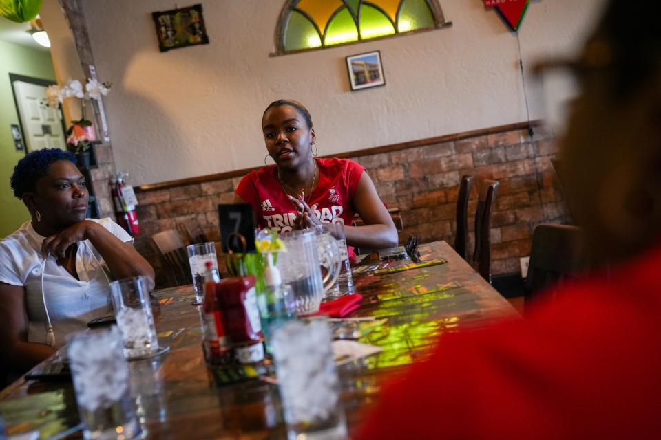 Margo Laing Wint (left) and Irma Banzi (center) talk about their experiences as Afro Caribbeans in Arizona at Topnotch Island Flavor Kitchen on Feb. 4, 2023, in Phoenix.