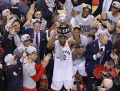 May 25, 2019; Toronto, Ontario, CAN; Toronto Raptors forward Kawhi Leonard (2) hoist the Eastern Conference trophy after winning game six of the Eastern conference finals of the 2019 NBA Playoffs against the Milwaukee Bucks at Scotiabank Arena. John E. Sokolowski-USA TODAY Sports
