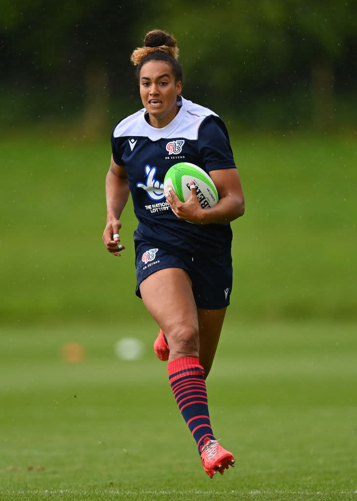 Megan running with a rugby ball