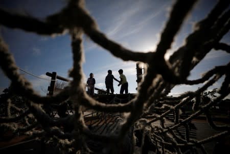 Children play as community members gather in a park to discuss gang violence in Manenberg township, Cape Town