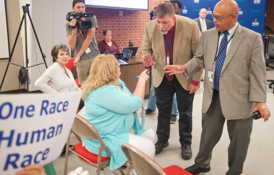 Jim Hearn, Jefferson County Public Schools security coordinator, and JCPS Security Chief Stanford Mullen tell a protester she will have to leave the Jefferson County Board of Education meeting after repeatedly shouting to be heard during a part of the meeting not open to public discussion.
June 22, 2021