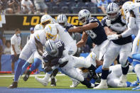 Dallas Cowboys running back Ezekiel Elliott (21) scores a touchdown during the first half of an NFL football game against the Los Angeles Chargers Sunday, Sept. 19, 2021, in Inglewood, Calif. (AP Photo/Ashley Landis )