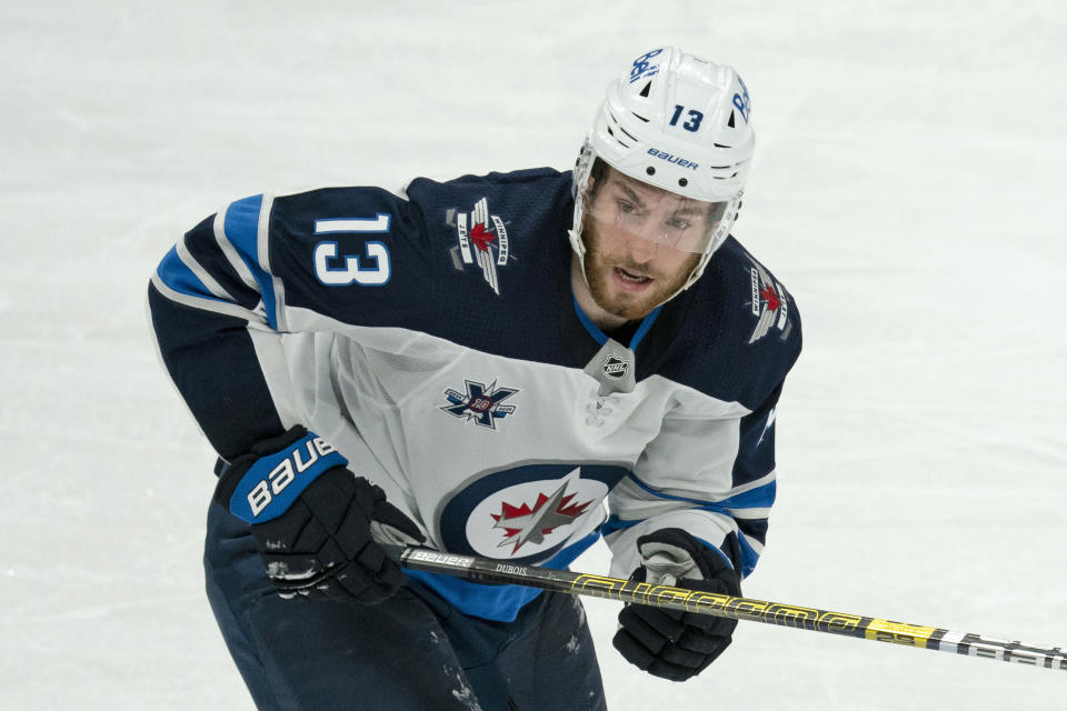 FILE - In this March 9, 2021, file photo, Winnipeg Jets center Pierre-Luc Dubois (13) skates during an NHL hockey game against the Toronto Maple Leafs in Toronto. Dubois is looking forward to finally getting to know his Jets teammates after spending much of last season in Winnipeg isolated from them due to COVID-19 protocols coupled with a rash of injuries. (AP Photo/Peter Power, File)