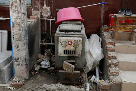 An abandoned coal-powered boiler is pictured beside a road in Xiaozhangwan village of Tongzhou district, on the outskirts of Beijing, China June 28, 2017. Picture taken June 28, 2017. REUTERS/Jason Lee