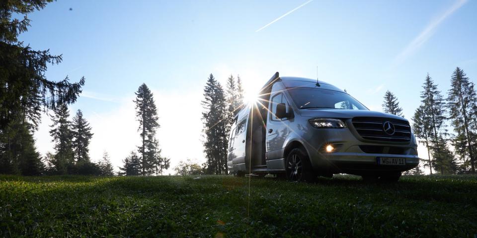 Alphavan's camper van in a grassy field.