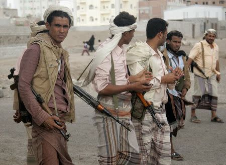 Armed members of the Popular Committee stand on a street in Yemen's southern port city of Aden January 22, 2015. REUTERS/Yaser Hasan