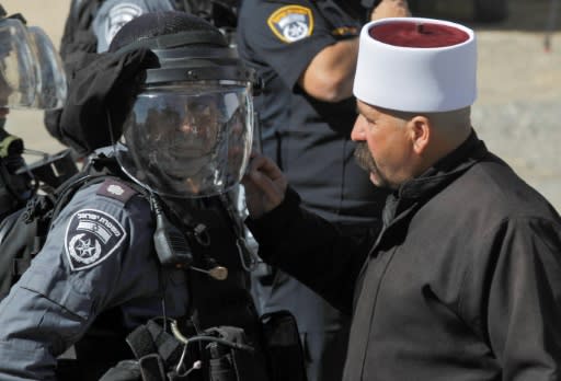 A Druze man speaks to Israeli security forces during a protest outside a polling centre in the village of Majdal Shams in the Israeli-annexed Golan Heights on October 30, 2018