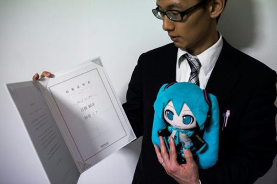 Mr Kondo tied the knot with Miku, in the form of a stuffed doll (both pictured)