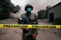 <p>A soldier keeps watch at a restricted area affected by an eruption from Fuego volcano in the community of San Miguel Los Lotes in Escuintla, Guatemala, June 4, 2018. (Photo: Luis Echeverria/Reuters) </p>