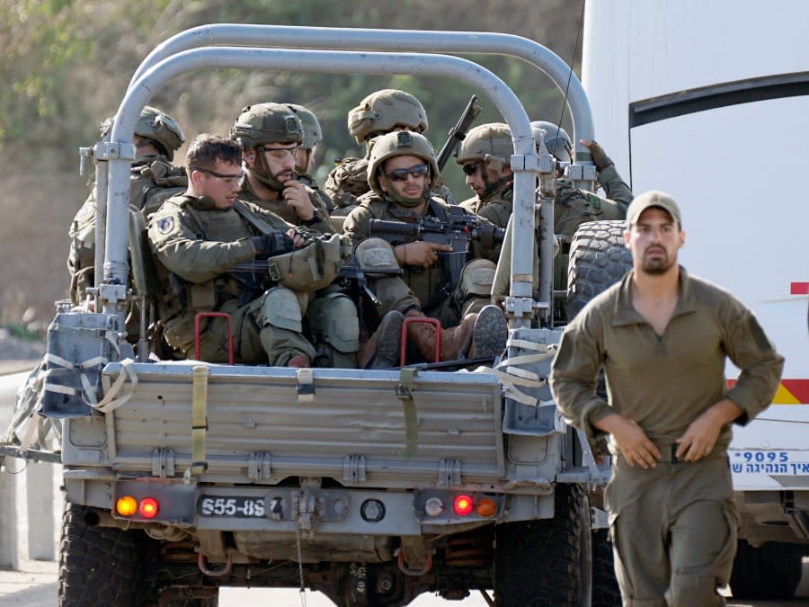 Israeli soldiers head south near Ashkelon, Israel, on Saturday, Oct. 7, 2023. Palestinian militants in the Gaza Strip infiltrated Saturday into southern Israel and fired thousands of rockets into the country while Israel began striking targets in Gaza in response. (AP Photo/Ohad Zwigenberg)