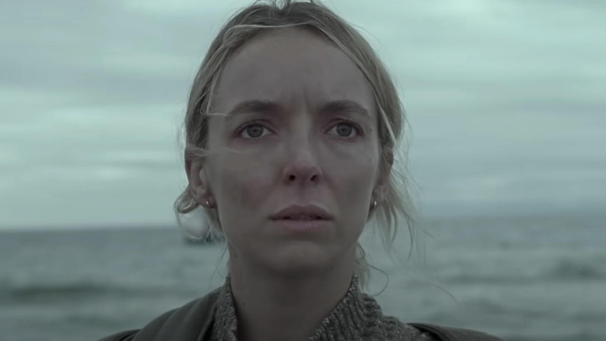  Close-up of Jodie Comer's Woman standing outside in front of water in The End We Start From. 