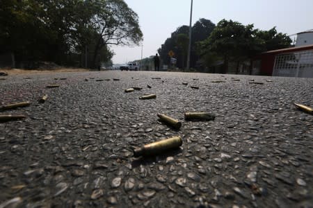 FILE PHOTO: Bullet casings lie on the street near a crime scene in Acapulco