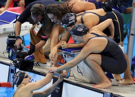 2016 Rio Olympics - Swimming - Final - Women's 4 x 200m Freestyle Relay Final - Olympic Aquatics Stadium - Rio de Janeiro, Brazil - 10/08/2016. Katie Ledecky (USA) of USA is congratulated by teammates Maya DiRado (USA) of USA, Leah Smith (USA) of USA and Allison Schmitt (USA) of USA after they won the gold medal. REUTERS/Dominic Ebenbichler