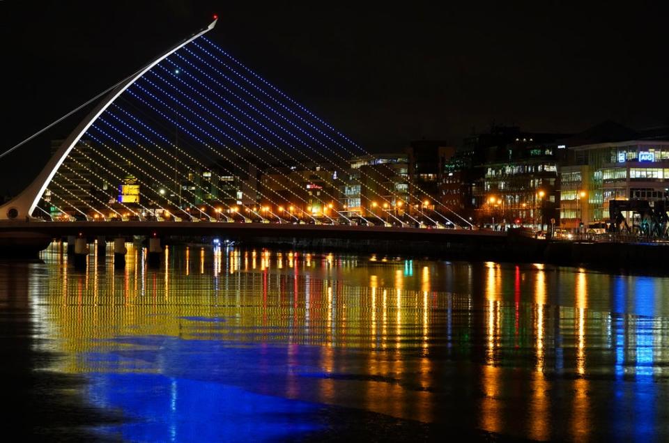 The Samuel Beckett Bridge in Dublin’s city centre displays the colours of the Ukrainian flag as a show of support. The country is sending body armour and meals to Ukrainian troops (Brian Lawless/PA) (PA Wire)