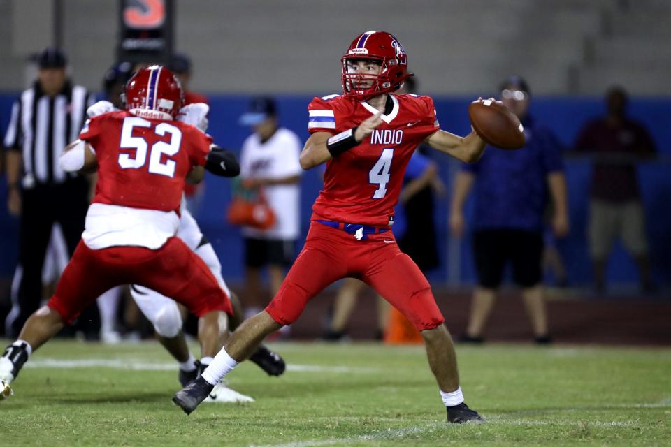 Indio High quarterback Fabian Garcia looks to pass against Cathedral City during their Desert Valley League football game in Indio, Calif., on Friday, Sept. 23, 2022. 