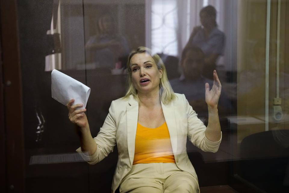 Marina Ovsyannikova, a former Russian state TV journalist who quit after making an on-air protest of Russia's military operation in Ukraine, gestures sitting in a court room during a hearing in Moscow, Russia, Thursday, Aug. 11, 2022. A court in Russia on Thursday ordered to place Ovsyannikova under house arrest for nearly two months pending investigation and trial on the charges of spreading false information about Russia's armed forces. If convicted, Ovsyannikova faces up to 10 years in prison under a new law that penalizes statements against the military and that was enacted shortly after Russian troops moved into Ukraine. (AP Photo/Alexander Zemlianichenko)