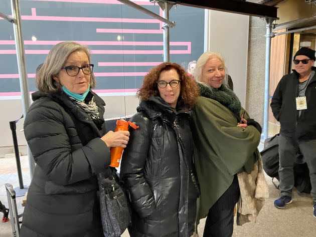 Above, (L-R) courtoom artists Elizabeth Williams, Jane Rosenberg and Christine Cornell wait to enter the courthouse for Trump's trial.