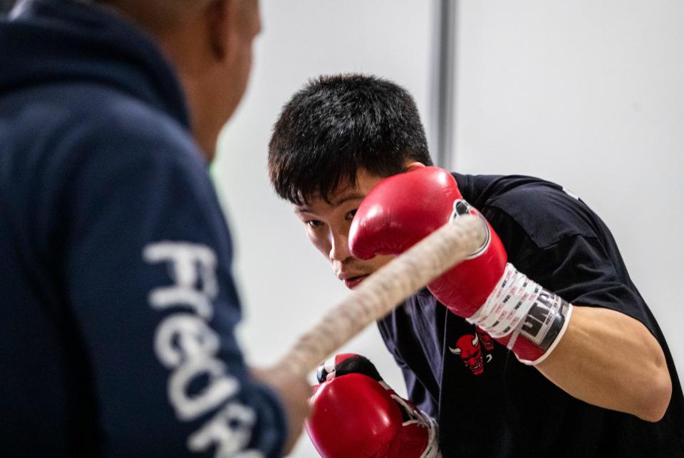 Brandun Lee works out with one of his trainers, Freddy Esparza, at his home in La Quinta, Calif., Tuesday, April 4, 2023. 