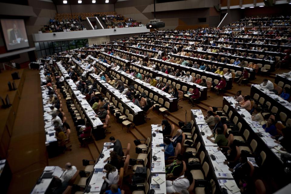 FILE - In this Dec. 21, 2018 file photo, members of the National Assembly debate the draft of a new constitution at Convention Palace in Havana, Cuba. Cuban legal experts told The Associated Press that they expect the Cuban government to send the National Assembly between 60 and 80 new laws over the next two years to replace ones rendered obsolete by the new constitution. (AP Photo/Ramon Espinosa, File)