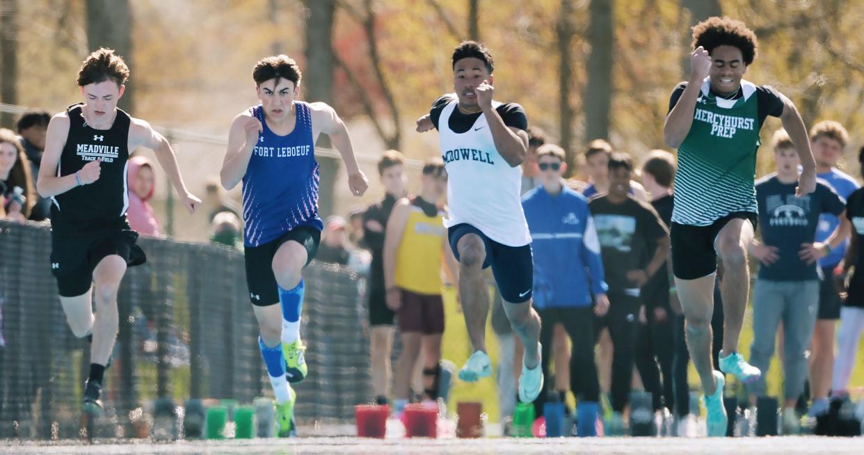 Athletes race during a boys 100-meter dash preliminary heat during the McDowell Invitational Track & Field meet.