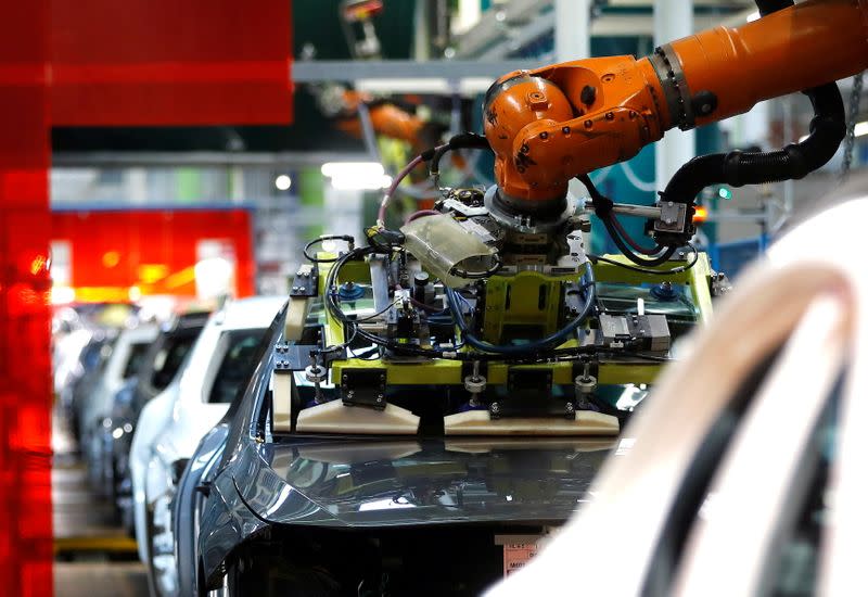 FILE PHOTO: A robot engineered by Kuka adjusts a windscreen in a fully automated process on a model of the A-class production line of German car manufacturer Mercedes Benz at the Daimler factory in Rastatt
