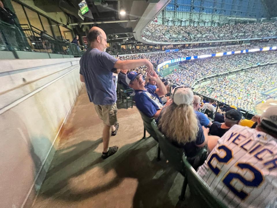 Ed Creech celebrates a Milwaukee Brewers home run on Tuesday by giving fans Ding Dongs. Creech has been giving surrounding fans near his seats Ding Dongs to celebrate home runs since 2018.