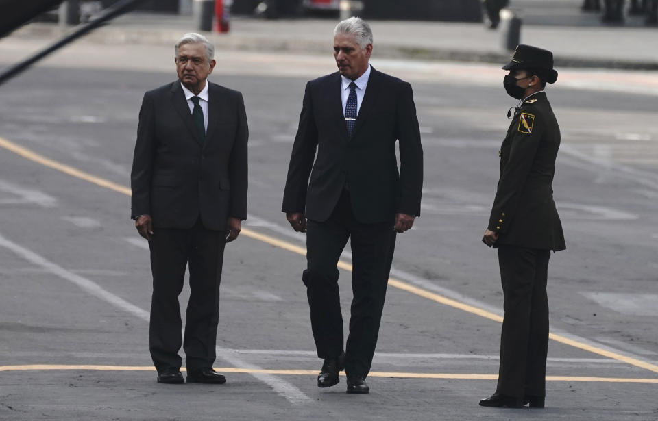 Cuba's President Miguel Diaz-Canel, center right, accompanies Mexico's President Andres Manuel Lopez Obrador, during Independence Day celebrations, in the Zocalo in Mexico City, Thursday, Sept. 16, 2021. (AP Photo/Marco Ugarte)