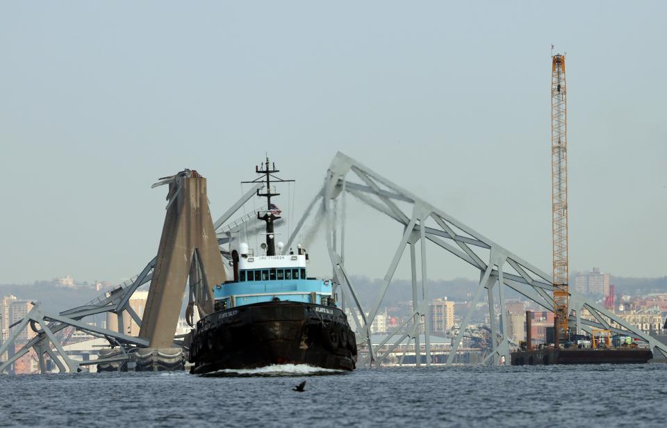 BALTIMORE, MARYLAND - MARCH 29: A crane works on clearing the debris from the Francis Scott Key Bridge on March 29, 2024 in Baltimore, Maryland. The bridge collapsed on Tuesday at 1:30AM, after being struck by the massive cargo ship Dali. Two members of a road repair crew were pulled from the Patapsco River immediately after the collision, while two other bodies were pulled from the water on Wednesday and four people remain missing and are presumed dead after the Coast Guard called off rescue efforts. The accident has temporarily closed the Port of Baltimore, one of the largest and busiest on the East Coast of the U.S. ( (Photo by Kevin Dietsch/Getty Images)