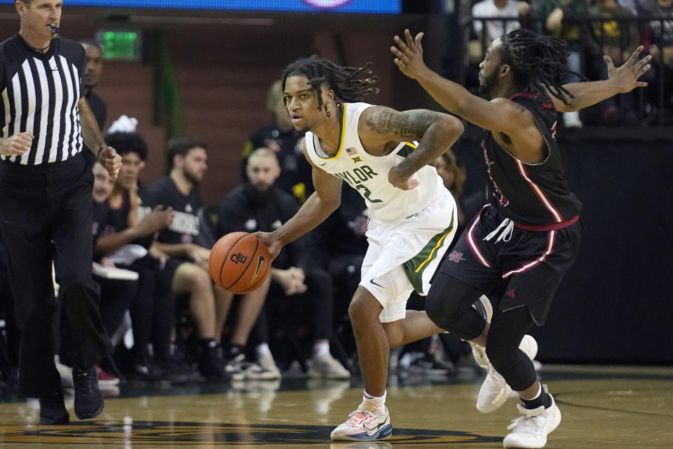 Baylor guard Jayden Nunn (2) dribbles against Nicholls State guard Micah Thomas during the second half of an NCAA college basketball game in Waco, Texas, Tuesday, Nov. 28, 2023. (AP Photo/LM Otero)