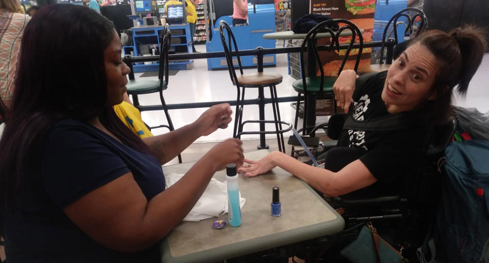 Walmart worker Ebony Harris stepped in to do Angela Peters’ nails after she was refused service at a nail salon because she ‘moved too much’. Source: Facebook/ Tasia Smith