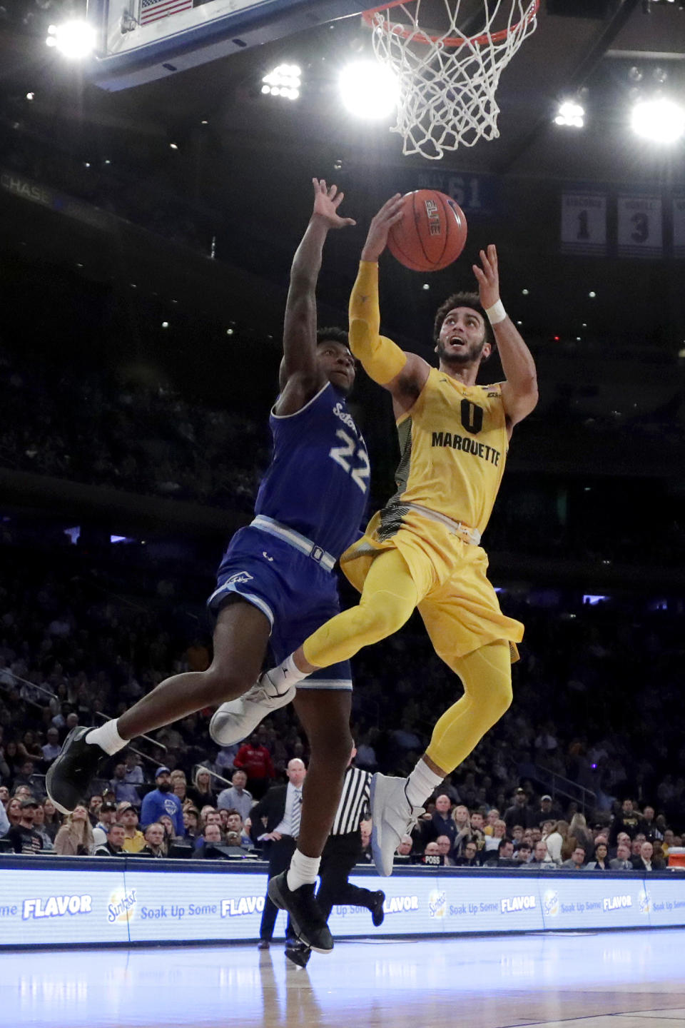 Marquette guard Markus Howard (0) goes up for a shot against Seton Hall guard Myles Cale (22) during the first half of an NCAA college basketball semifinal game in the Big East men's tournament, Friday, March 15, 2019, in New York. (AP Photo/Julio Cortez)